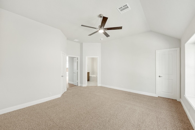 spare room with lofted ceiling, light colored carpet, and ceiling fan