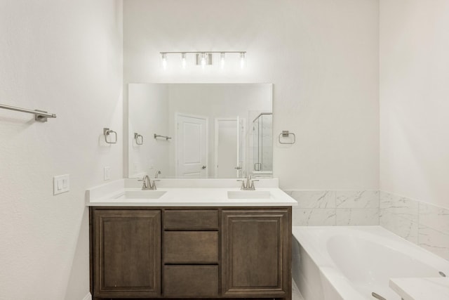 bathroom featuring plus walk in shower and vanity