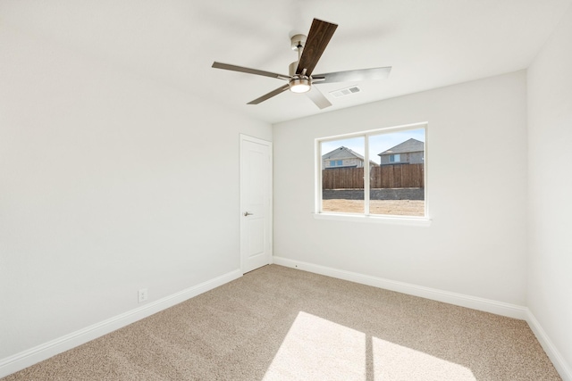 carpeted spare room with ceiling fan