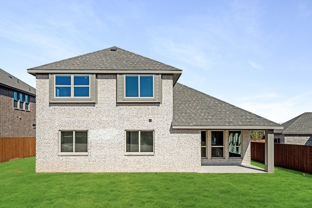 rear view of house featuring a patio and a lawn