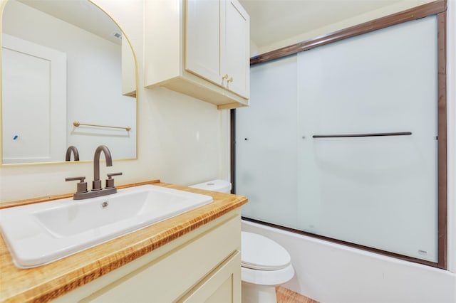 full bathroom with shower / bath combination with glass door, vanity, and toilet