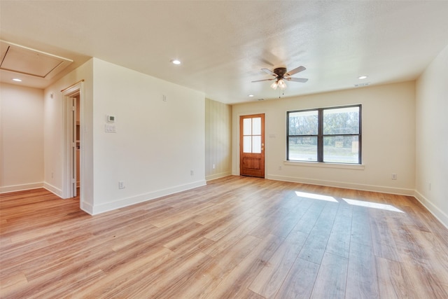 empty room with light wood-type flooring and ceiling fan