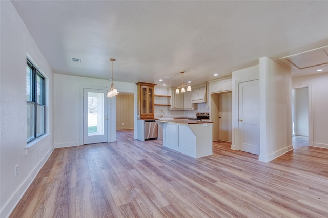 kitchen with backsplash, stainless steel appliances, light hardwood / wood-style floors, a kitchen island, and hanging light fixtures