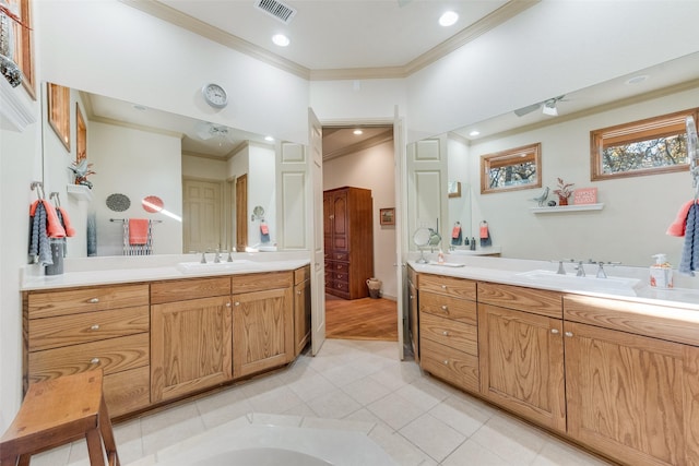 bathroom with tile patterned flooring, vanity, toilet, and crown molding