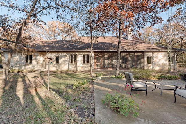 rear view of property featuring a patio