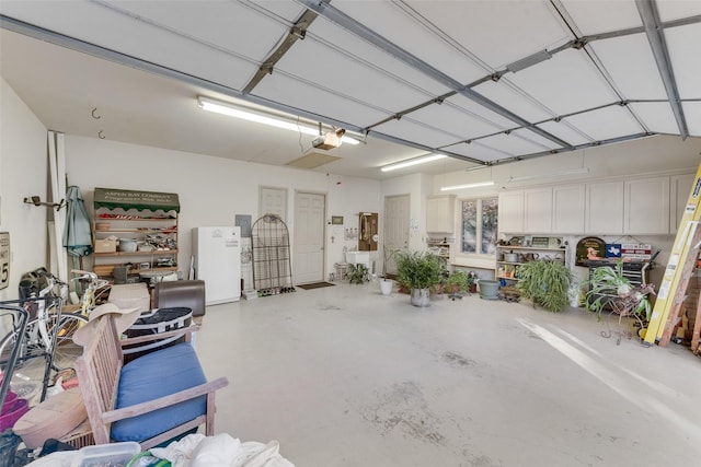 garage featuring a garage door opener and white refrigerator