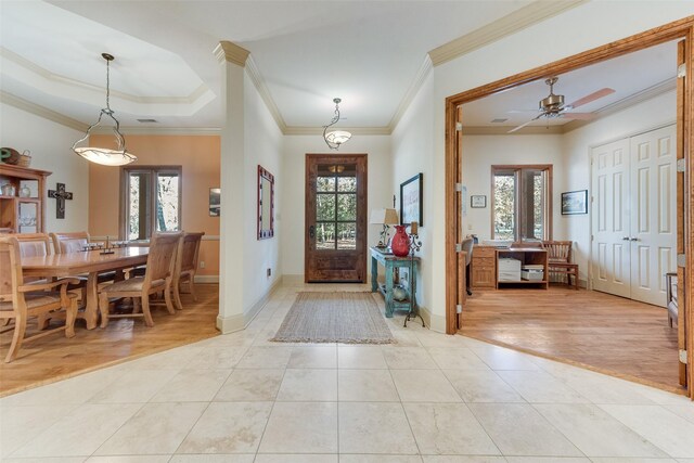 foyer with crown molding, ceiling fan, and light hardwood / wood-style floors