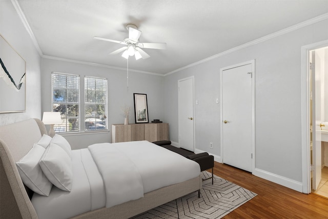 bedroom with hardwood / wood-style flooring, ensuite bathroom, ceiling fan, and ornamental molding