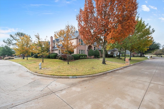 view of front of home featuring a residential view and a front lawn