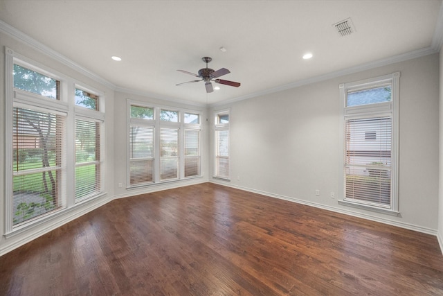 spare room featuring dark hardwood / wood-style flooring, ornamental molding, and ceiling fan