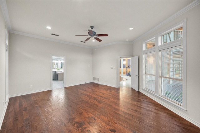 empty room featuring ornamental molding, dark wood-type flooring, and ceiling fan