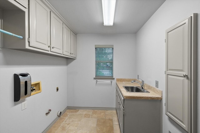 laundry area featuring a sink, stone finish flooring, hookup for a washing machine, baseboards, and electric dryer hookup
