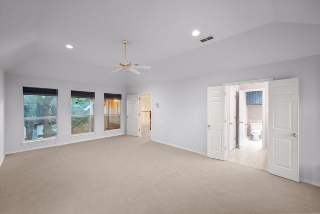 carpeted empty room with ceiling fan and vaulted ceiling