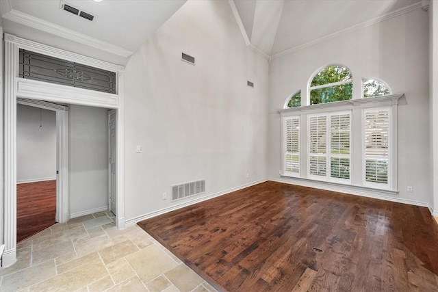 interior space with crown molding, high vaulted ceiling, and light wood-type flooring