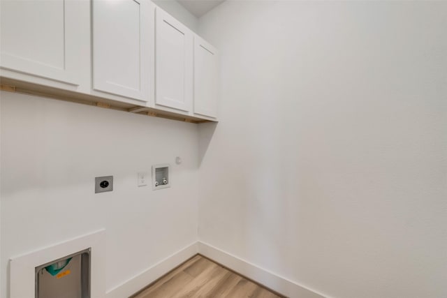 clothes washing area featuring hookup for a washing machine, light hardwood / wood-style flooring, cabinets, and hookup for an electric dryer