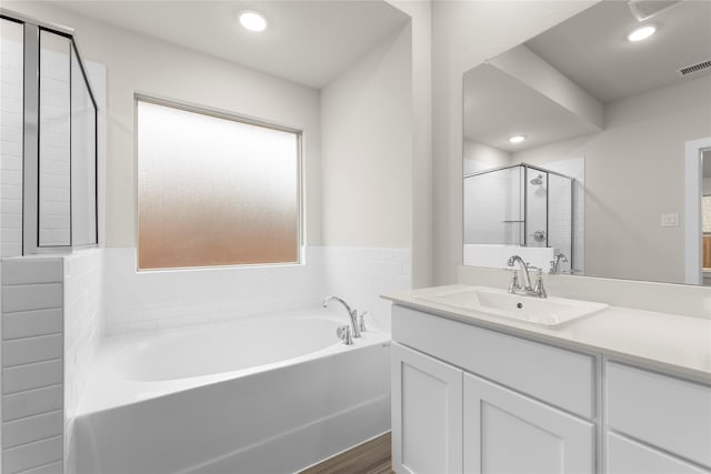 bathroom with recessed lighting, visible vents, vanity, a shower stall, and a bath