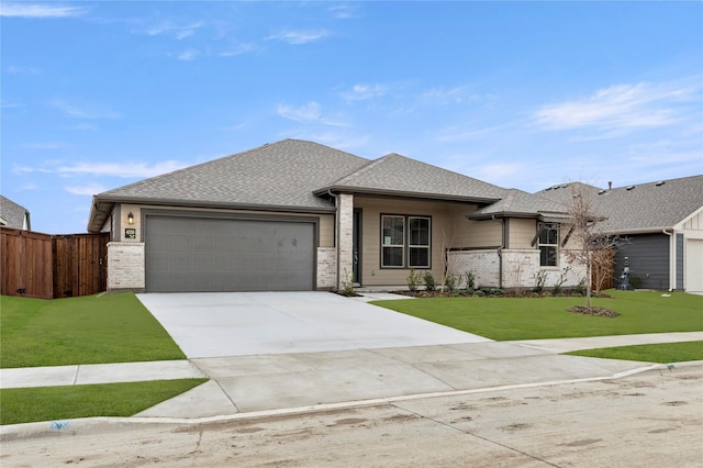 view of front of house featuring a garage, concrete driveway, fence, a front lawn, and brick siding