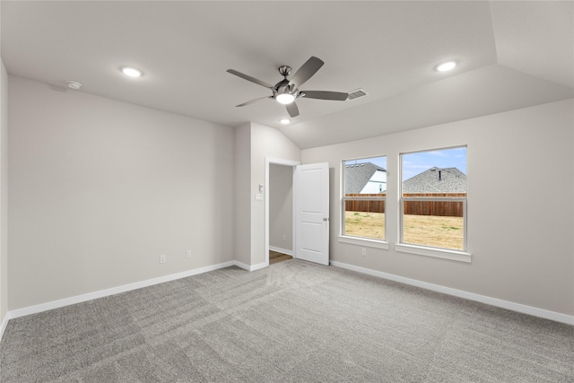 unfurnished bedroom with carpet floors, lofted ceiling, visible vents, and baseboards