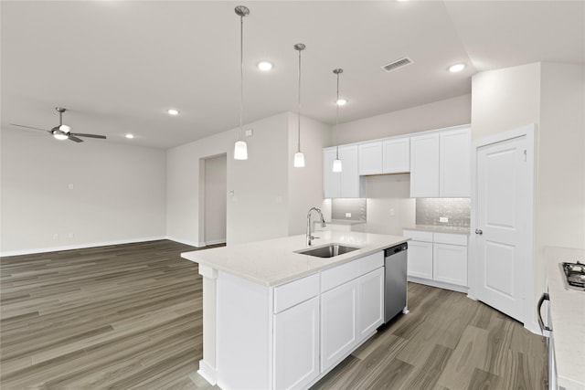 kitchen featuring stainless steel dishwasher, visible vents, light wood finished floors, and a sink