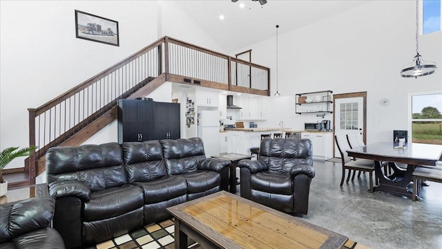 living room with high vaulted ceiling