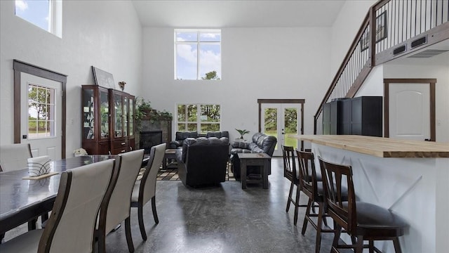 dining area featuring a high ceiling and french doors