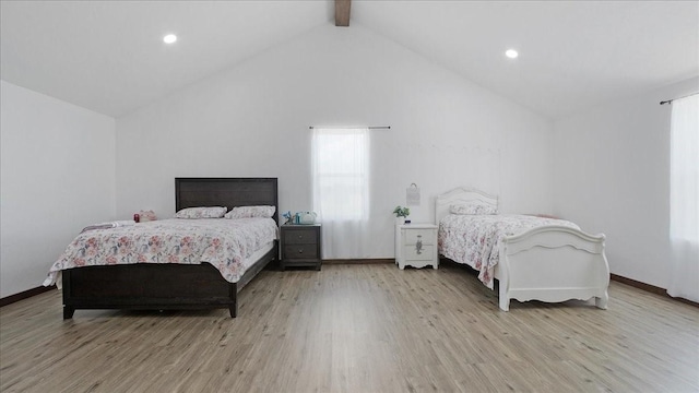 bedroom featuring beamed ceiling, light wood-type flooring, and high vaulted ceiling