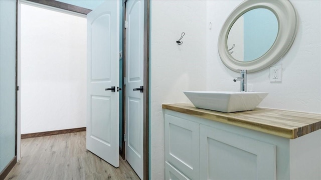 bathroom with vanity and hardwood / wood-style flooring