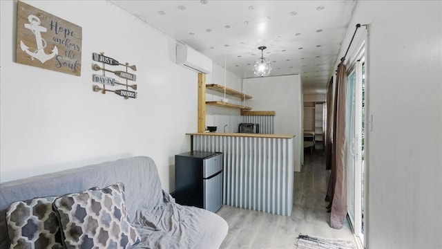 interior space with light hardwood / wood-style floors and a wall unit AC