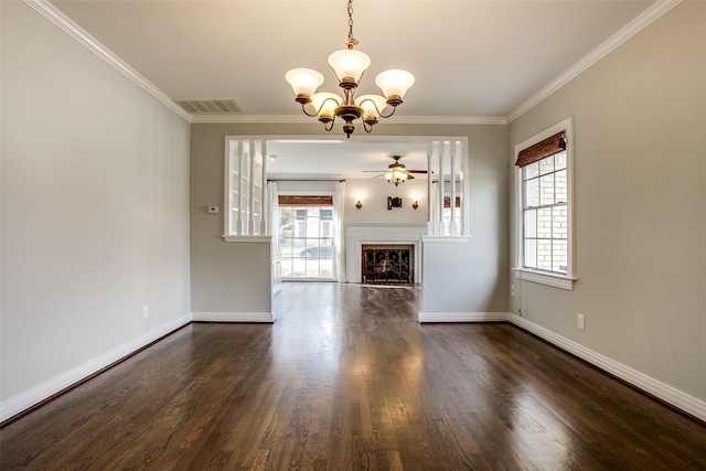 unfurnished living room featuring crown molding, a healthy amount of sunlight, and ceiling fan with notable chandelier