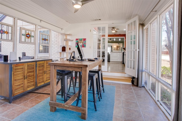 interior space with ceiling fan, tile patterned floors, and a healthy amount of sunlight