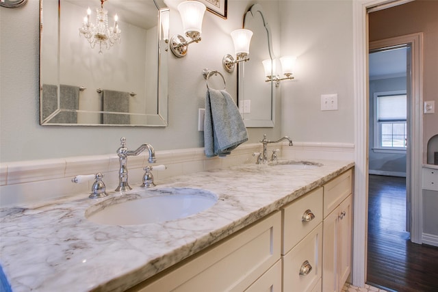 bathroom with hardwood / wood-style flooring, vanity, and crown molding