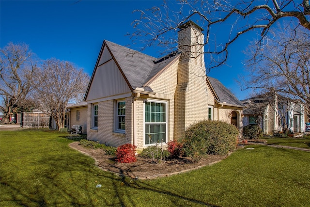 view of side of property with a lawn