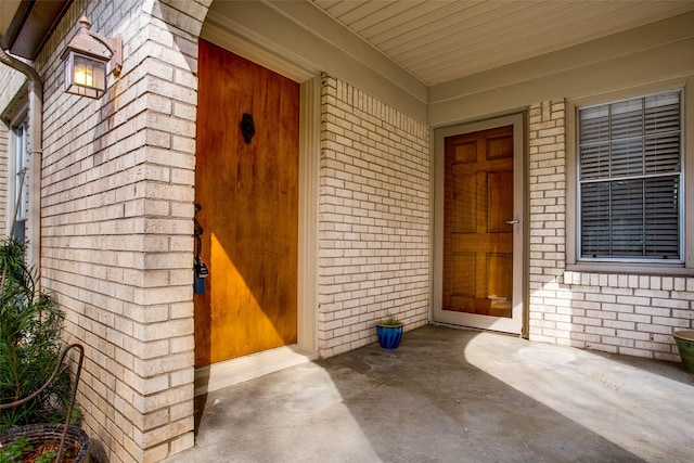 view of exterior entry featuring a porch