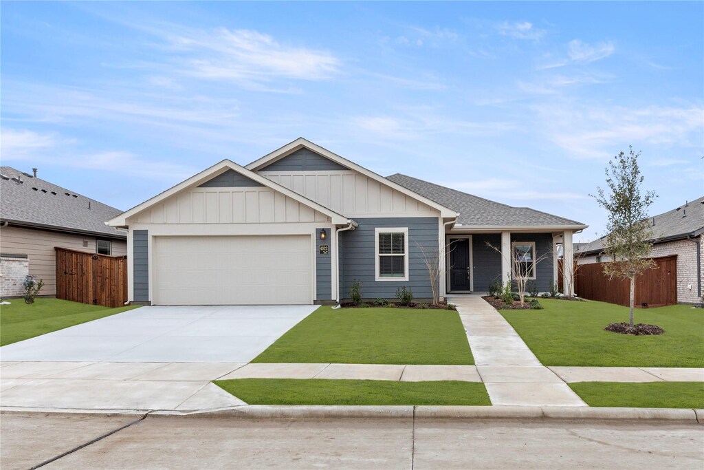 view of front of property featuring a garage and a front lawn