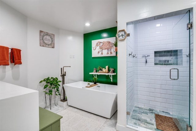 bathroom featuring shower with separate bathtub