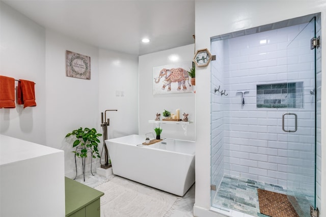 bathroom featuring independent shower and bath