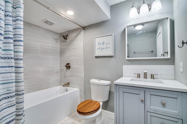 full bathroom with shower / tub combo with curtain, vanity, and toilet