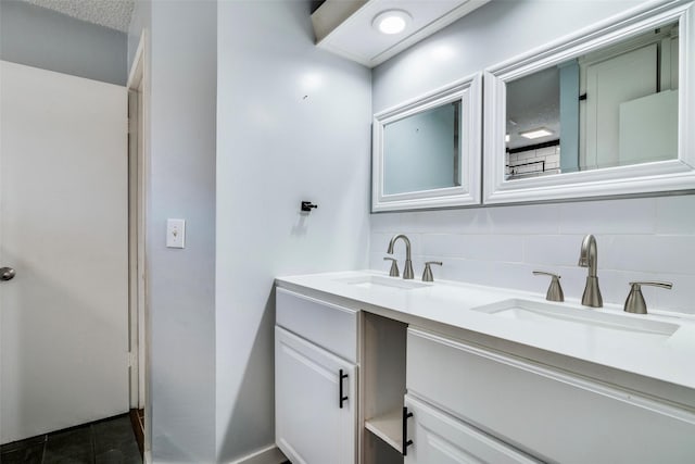 bathroom featuring tile patterned floors, vanity, and tasteful backsplash