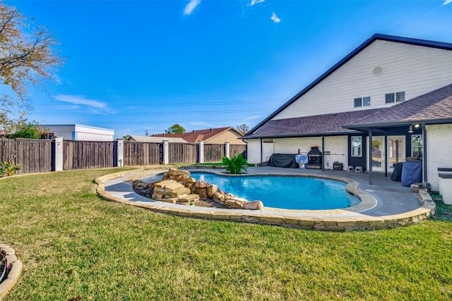 view of pool with a yard