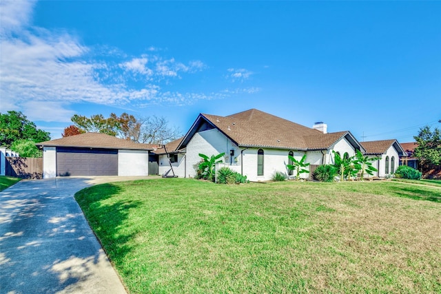 view of front of house with a garage and a front lawn