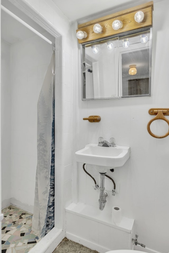 bathroom with sink and a shower with shower curtain