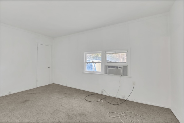 carpeted empty room featuring cooling unit and ornamental molding