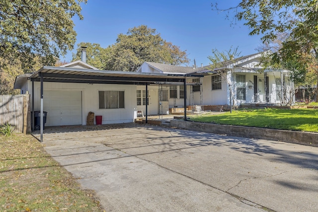 ranch-style house with a front yard, a porch, a garage, and a carport