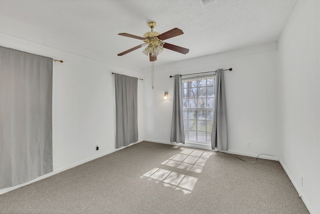 spare room with ceiling fan, carpet, and a textured ceiling