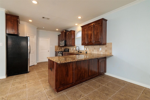 kitchen with kitchen peninsula, appliances with stainless steel finishes, tasteful backsplash, crown molding, and stone counters