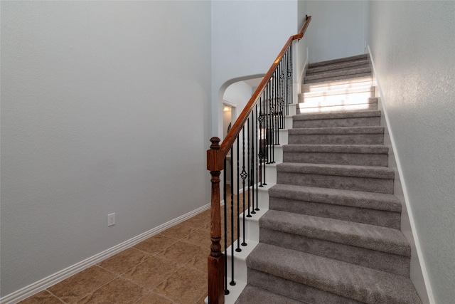 staircase featuring tile patterned floors