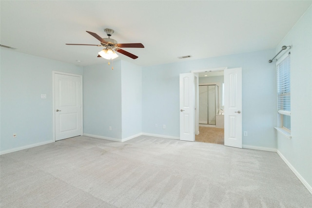 carpeted empty room featuring ceiling fan