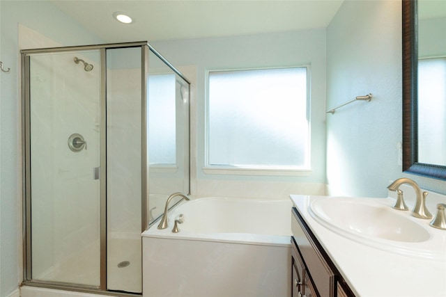 bathroom with vanity and independent shower and bath