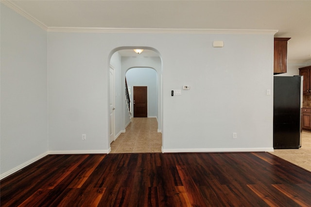 unfurnished room with light wood-type flooring and ornamental molding