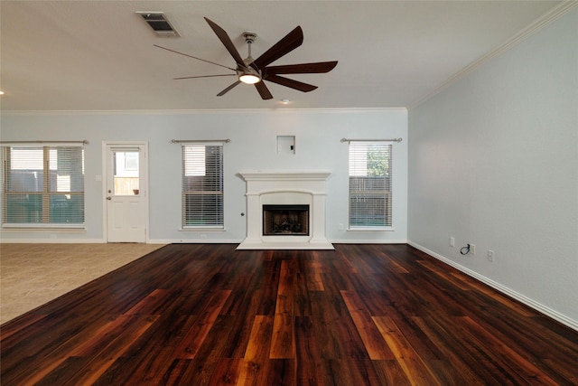 unfurnished living room featuring ceiling fan, crown molding, and dark wood-type flooring